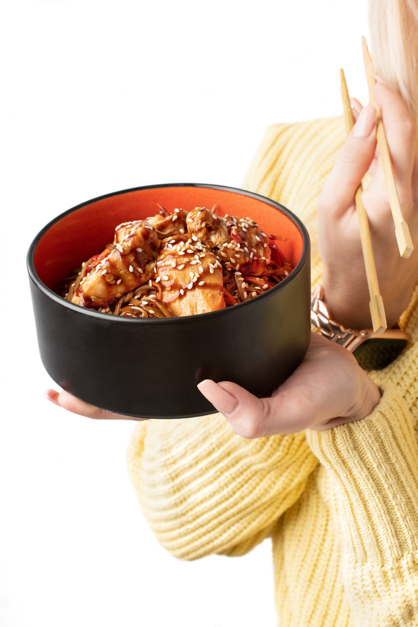 hands holding prepared meal in bowl